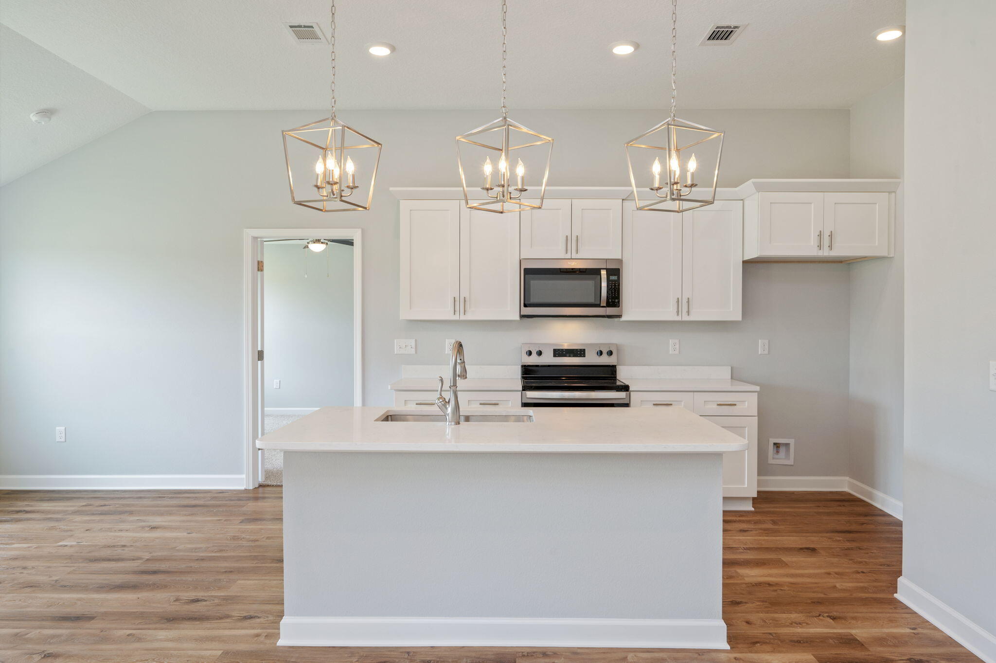 3851 Poverty Creek Road Crestview, FL 32539 - Photo 8 of 32 a kitchen with kitchen island granite countertop a sink cabinets and stainless steel appliances