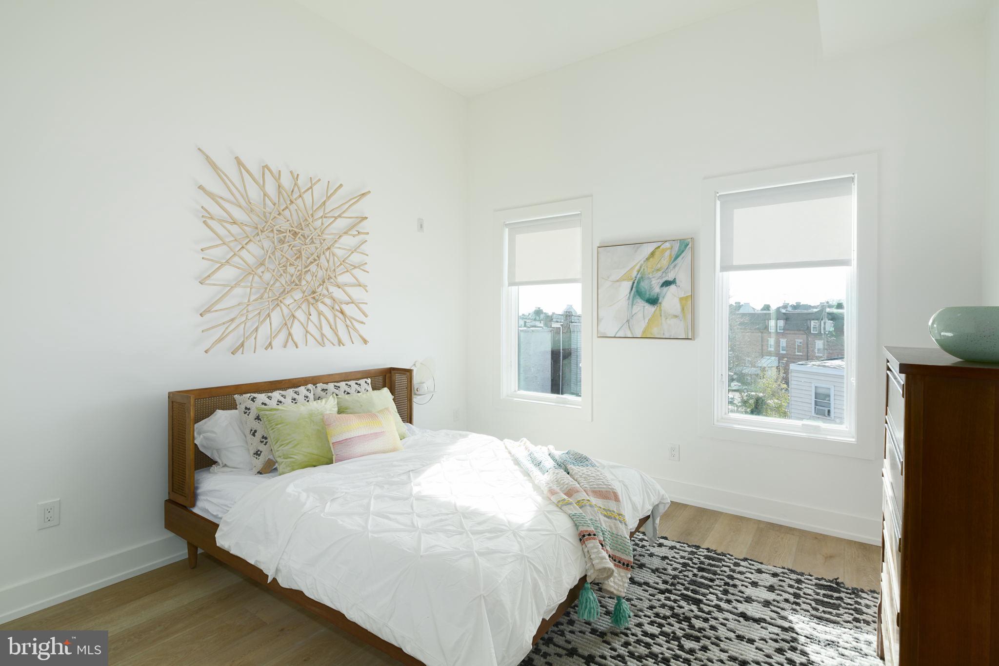 5013 Springfield Avenue, Unit 515 Philadelphia, PA 19143 - Photo 11 of 21 a bedroom with a bed and wooden floor