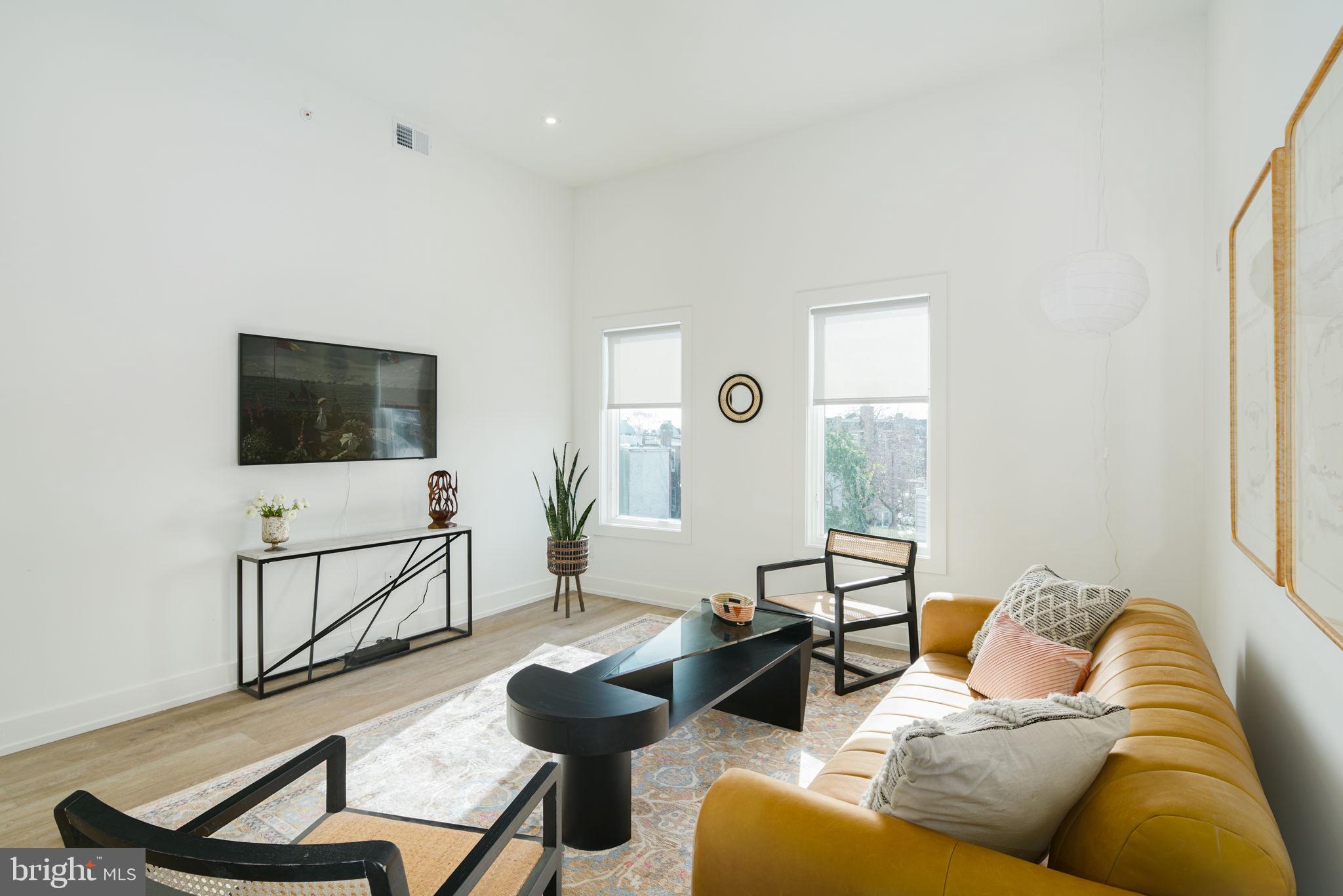 5013 Springfield Avenue, Unit 515 Philadelphia, PA 19143 - Photo 3 of 21 a living room with furniture and a flat screen tv