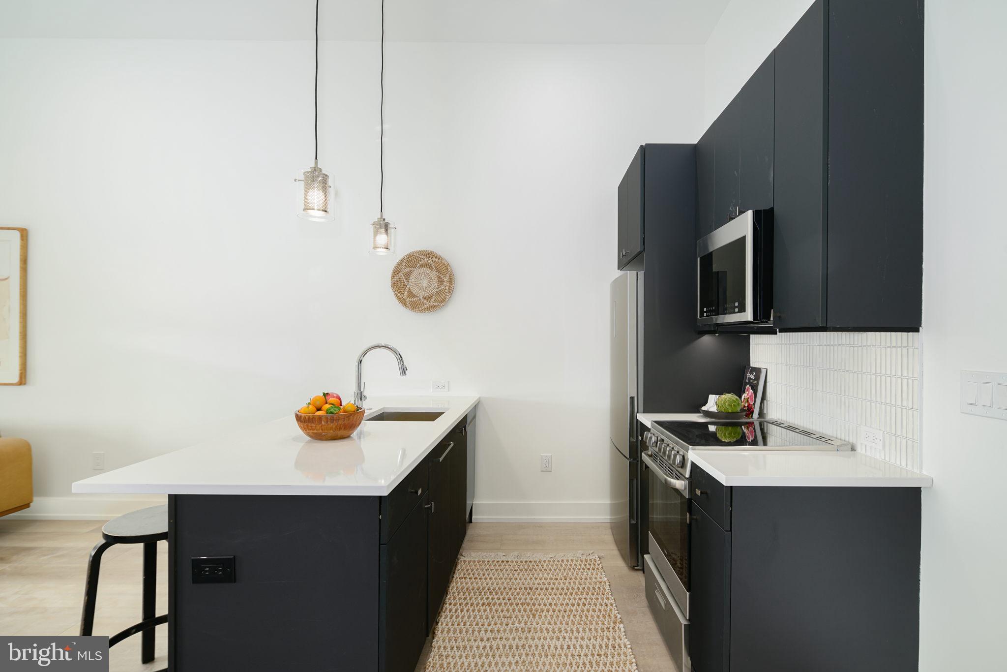 5013 Springfield Avenue, Unit 515 Philadelphia, PA 19143 - Photo 9 of 21 a bathroom with a sink and a mirror