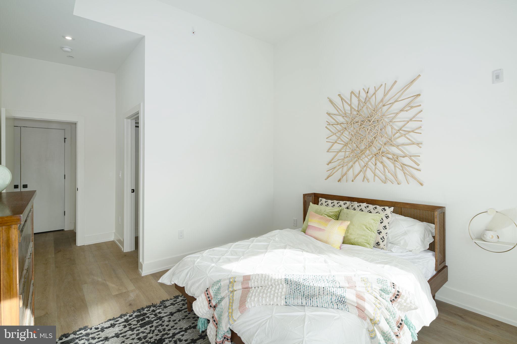 5013 Springfield Avenue, Unit 515 Philadelphia, PA 19143 - Photo 10 of 21 a bedroom with a bed and a painting on the wall