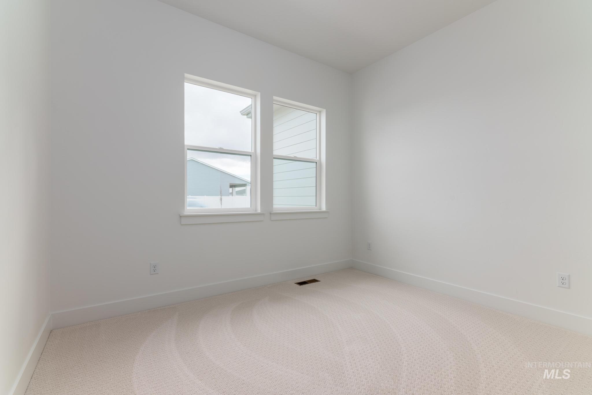 8501 South Country Wind Avenue Meridian, ID 83642 - Photo 24 of 39 Unfurnished room with light colored carpet and baseboards
