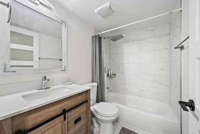 a bathroom with a sink toilet and shower