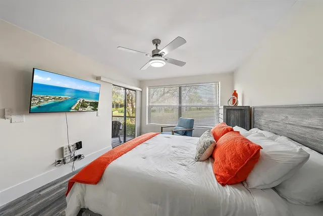 a bedroom with a bed and a large window
