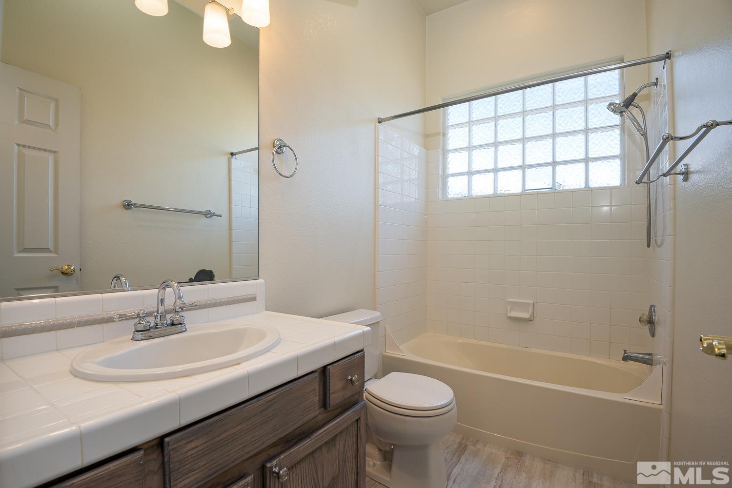 970 Stadium View Court Reno, NV 89512 - Photo 19 of 30 a bathroom with a sink a toilet and shower