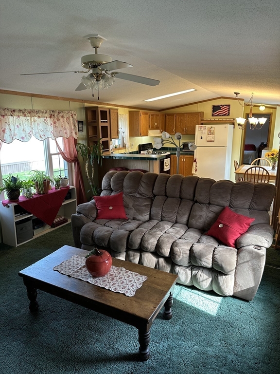 72 Quaboag Valley, Unit 70 Palmer, MA 01069 - Photo 11 of 21 a living room with furniture a rug and a floor to ceiling window