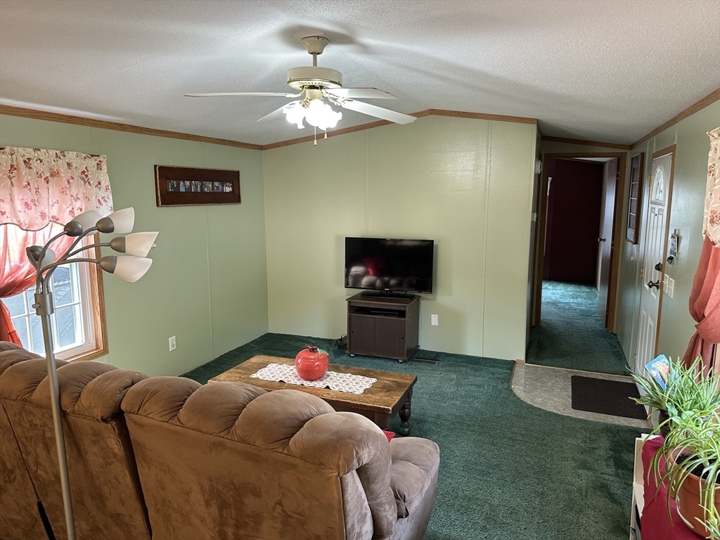 72 Quaboag Valley, Unit 70 Palmer, MA 01069 - Photo 12 of 21 a living room with furniture and a flat screen tv