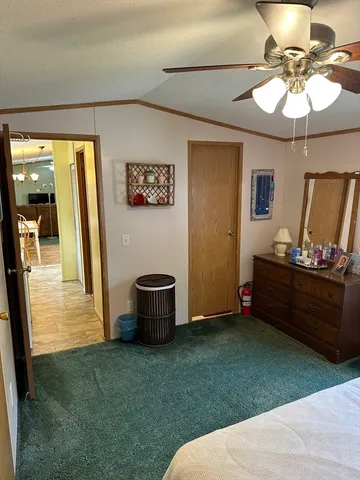 a bed room with a bed and a chandelier