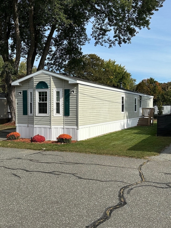 72 Quaboag Valley, Unit 70 Palmer, MA 01069 - Photo 3 of 21 a front view of a house with a yard and garage