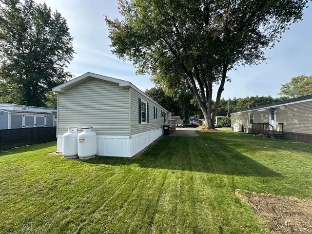 a front view of house with yard and green space