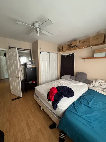 a bedroom with a bed and a chandelier