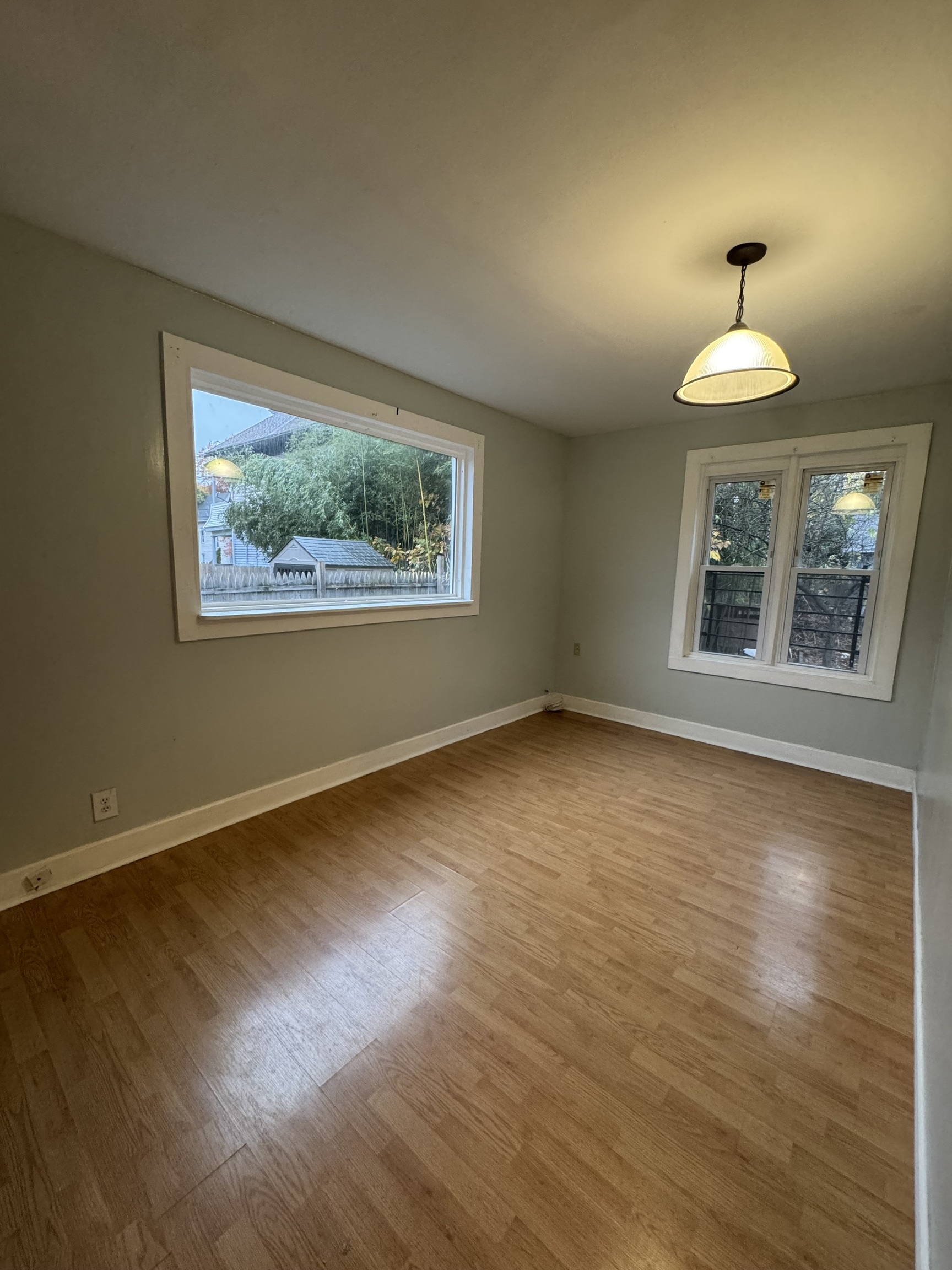 731 George Street New Haven, CT 06511 - Photo 3 of 25 a view of an empty room with wooden floor a window and a chandelier