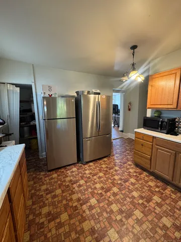 a kitchen with granite countertop a refrigerator and a sink