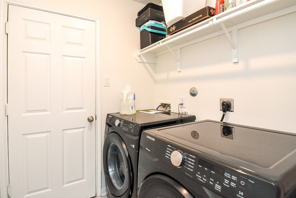5912 Whitewing Road Rosenberg, TX 77469 - Photo 25 of 25 This efficient laundry room features modern appliances and convenient shelving for all your storage needs.