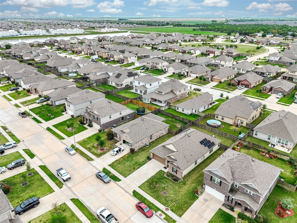 5912 Whitewing Road Rosenberg, TX 77469 - Photo 3 of 25 Explore this inviting neighborhood from above, showcasing well-maintained homes with spacious yards and scenic surroundings. Perfect for comfortable family living.