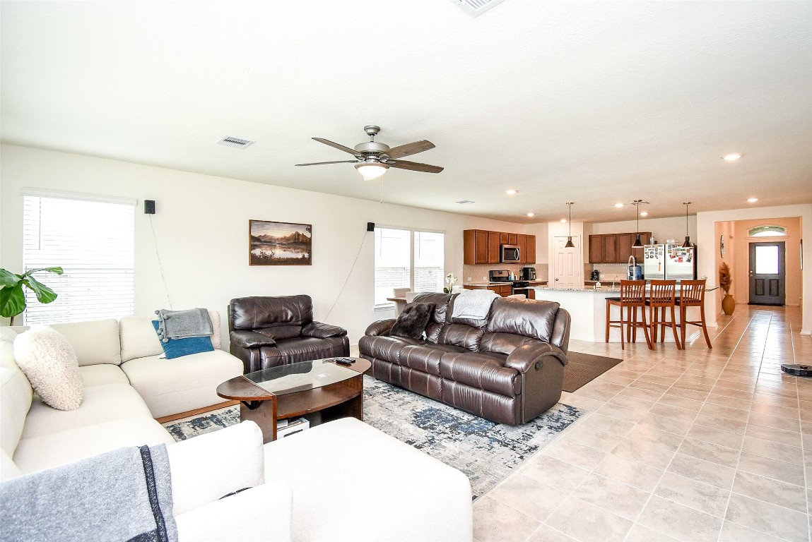 5912 Whitewing Road Rosenberg, TX 77469 - Photo 10 of 25 This inviting living room offers generous space for relaxation and entertainment, seamlessly connecting to the kitchen for a perfect flow.