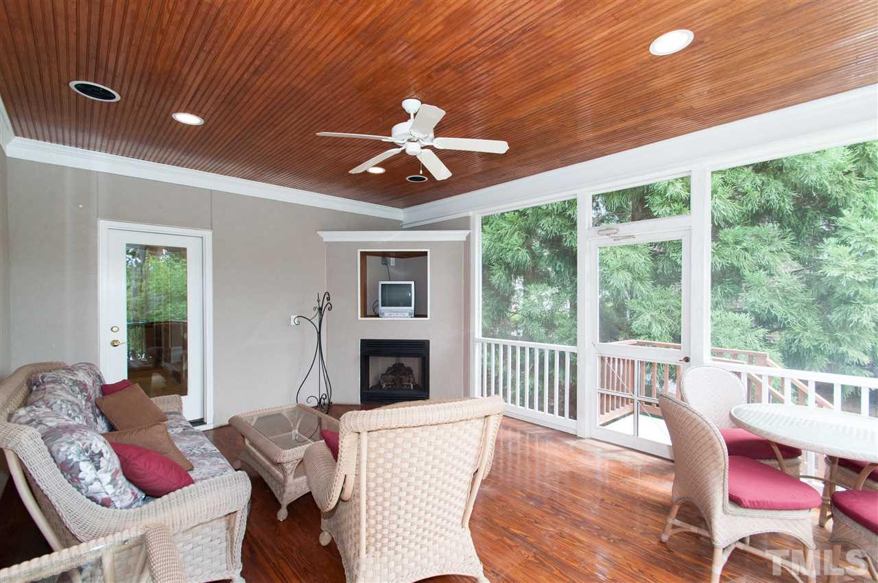 10529 Charmford Way Raleigh, NC 27615 - Photo 22 of 25 a living room with furniture fireplace and a large window