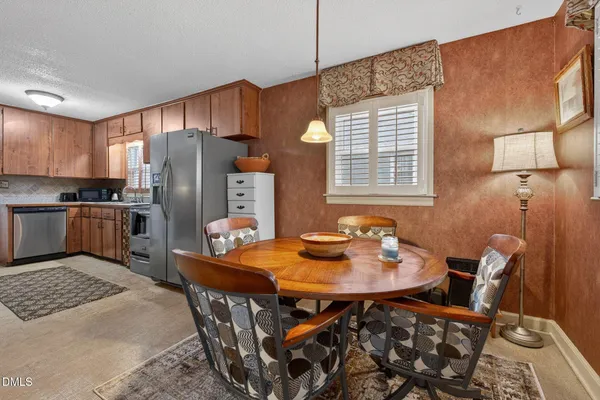 a dining room with furniture and window