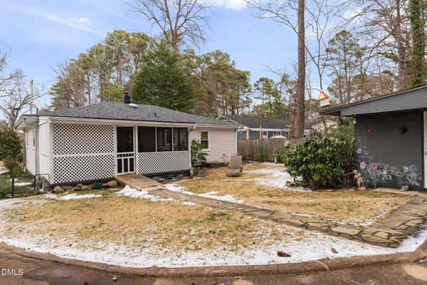 a view of a house with a yard covered in snow