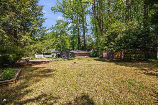 a view of a backyard with a tree