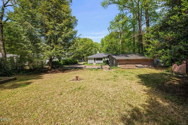 a view of backyard with swimming pool and outdoor seating