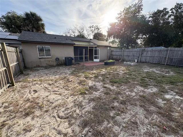 a view of a yard in front of a house with a large tree