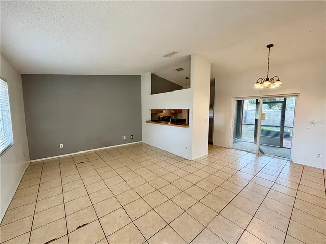 a view of a livingroom with wooden floor and cabinet