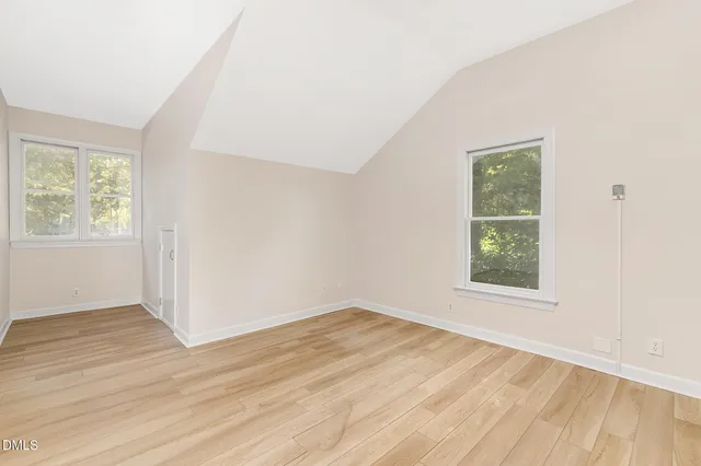 a kitchen with kitchen island granite countertop a table chairs sink and cabinets
