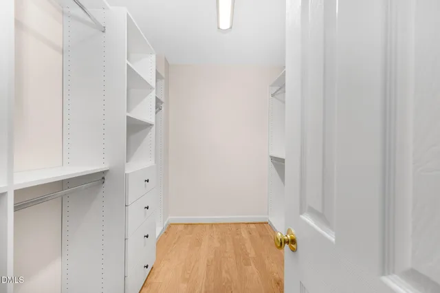 a bathroom with a double vanity sink a large mirror and a bathtub