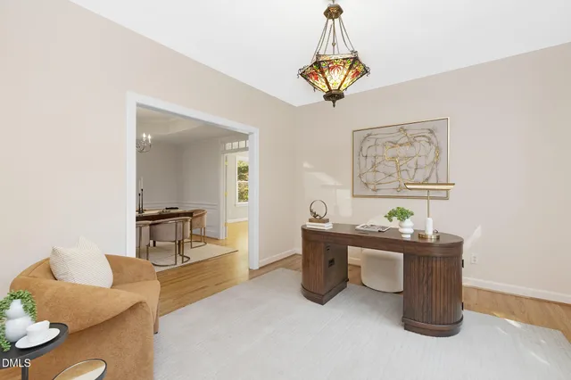 a dining room with kitchen island stainless steel appliances a sink and a chandelier