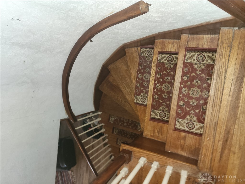 1436 Ruskin Road Dayton, OH 45406 - Photo 16 of 29 Ascend this striking wooden staircase with elegant carpet runners.