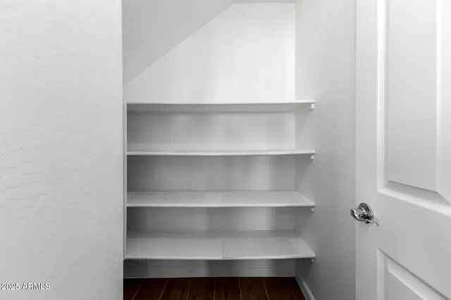 a spacious bathroom with a tub sink and mirror