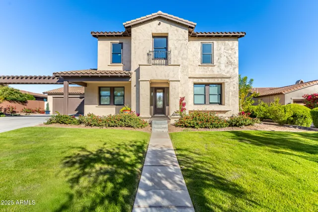 a front view of a house with yard and green space