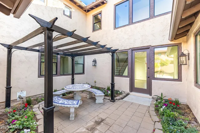 a front view of a house with outdoor seating and flowers