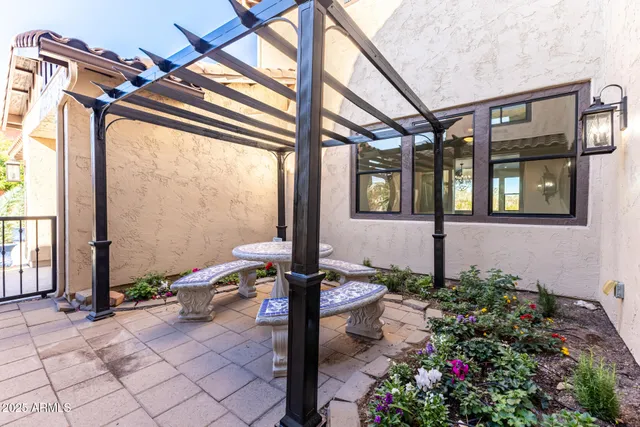 a front view of a house with outdoor seating and plants