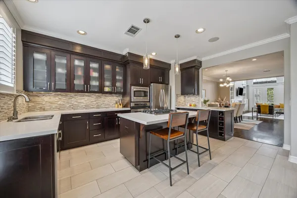 a kitchen with a sink counter top space appliances and a center island