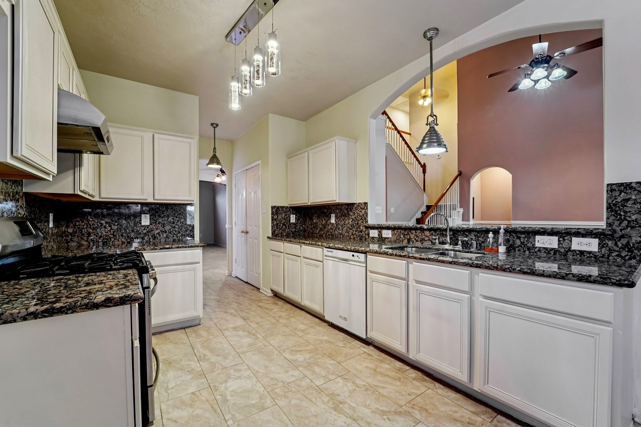 3818 Ridge Canyon Road Baytown, TX 77521 - Photo 3 of 32 a modern kitchen with stainless steel appliances granite countertop a stove a sink and a microwave