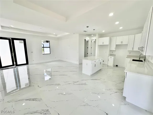 a kitchen with stainless steel appliances granite countertop a refrigerator a stove a sink and a refrigerator