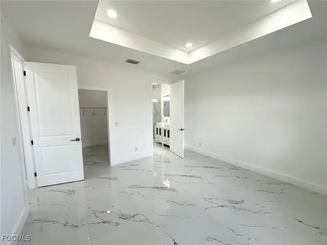 a spacious bathroom with double sink and a mirror