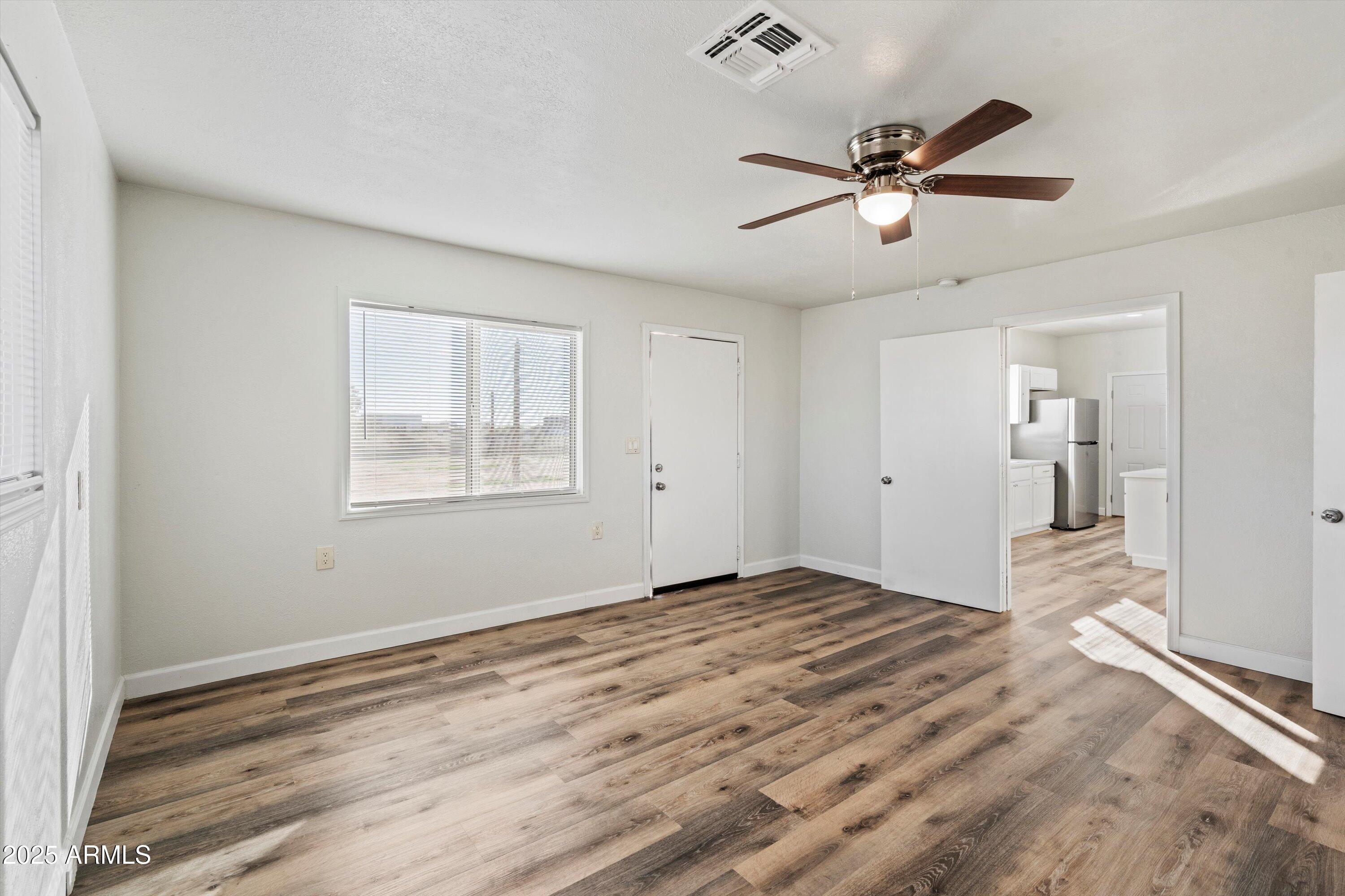 37701 West Buckeye Road Tonopah, AZ 85354 - Photo 12 of 35 a view of empty room with wooden floor and fan