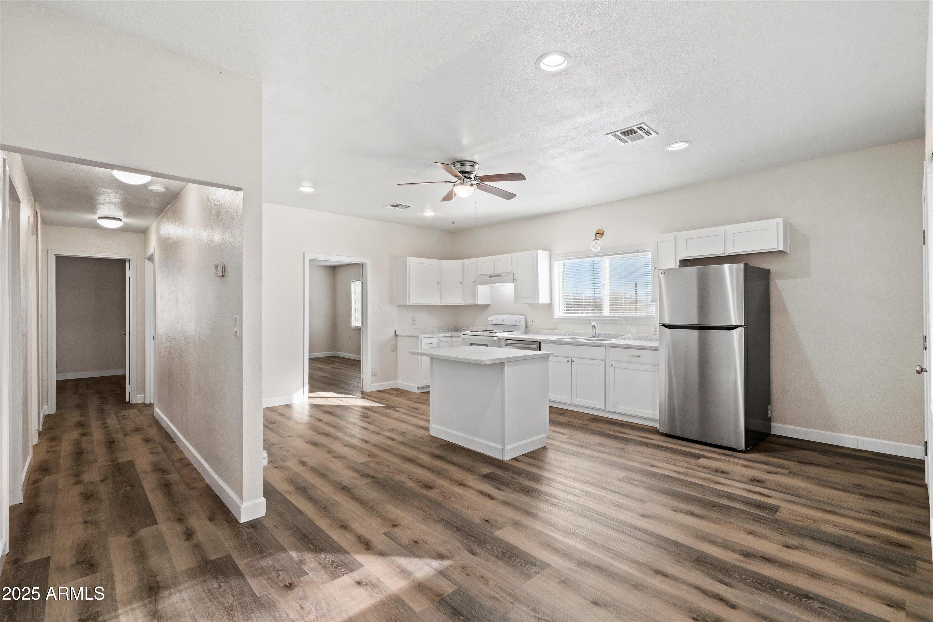 37701 West Buckeye Road Tonopah, AZ 85354 - Photo 17 of 35 a open kitchen with white cabinets and stainless steel appliances
