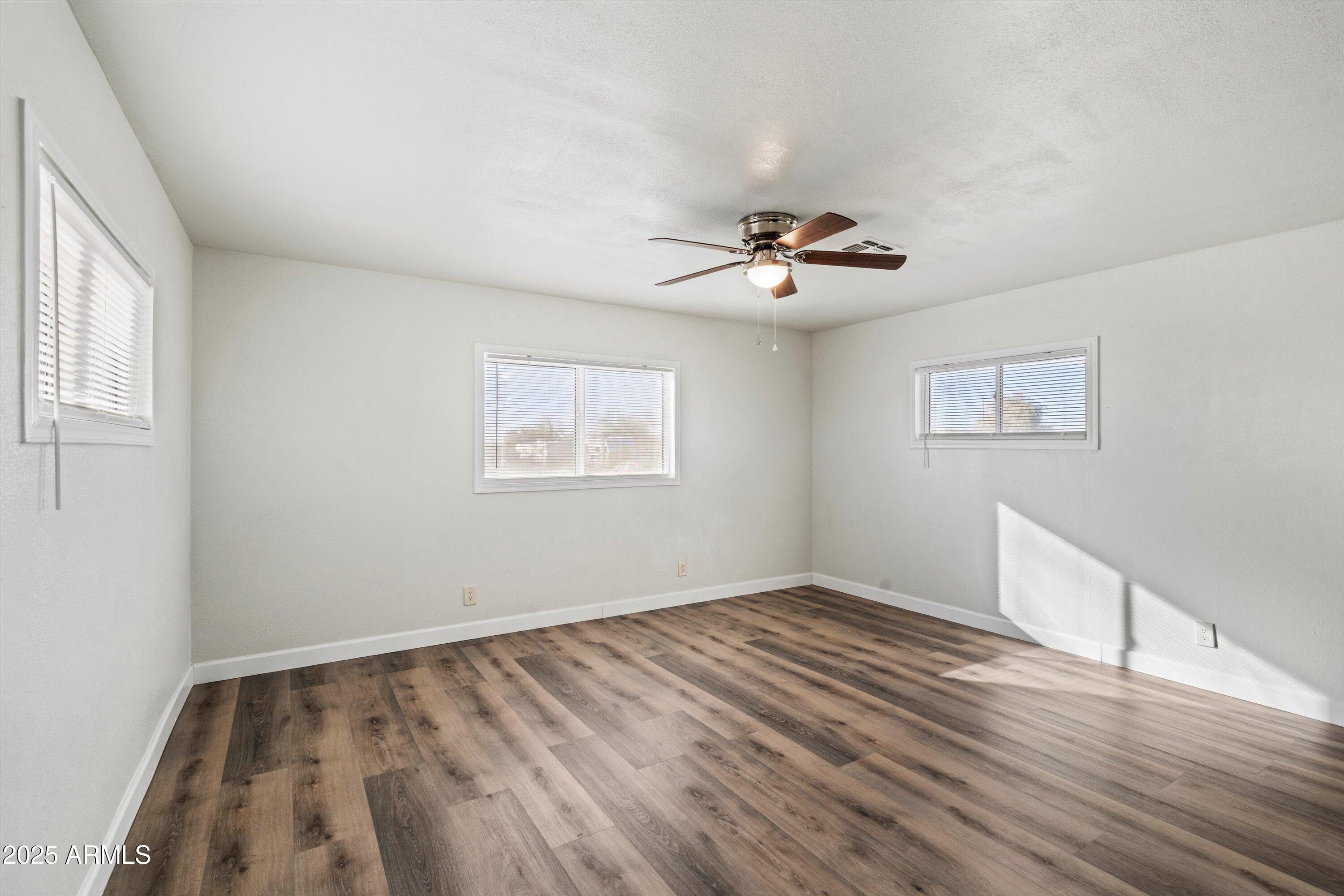 37701 West Buckeye Road Tonopah, AZ 85354 - Photo 24 of 35 a view of empty room with wooden floor
