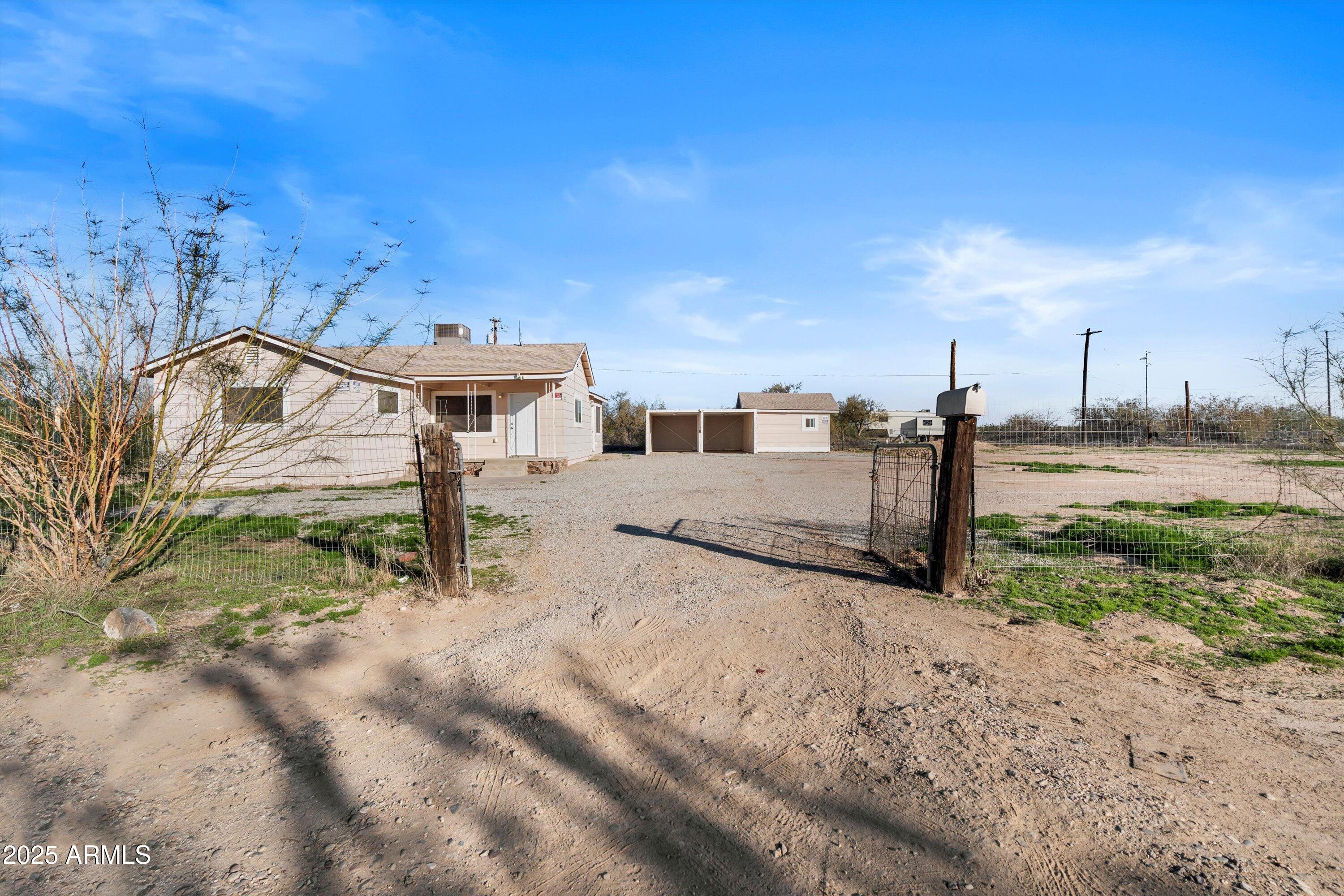 37701 West Buckeye Road Tonopah, AZ 85354 - Photo 7 of 35 a view of a dry yard with wooden fence