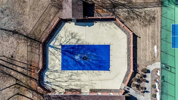 a aerial view of a house with a yard and large tree