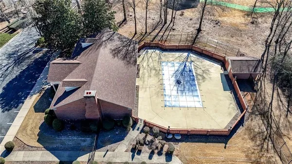 a living room with furniture a flat screen tv and a window
