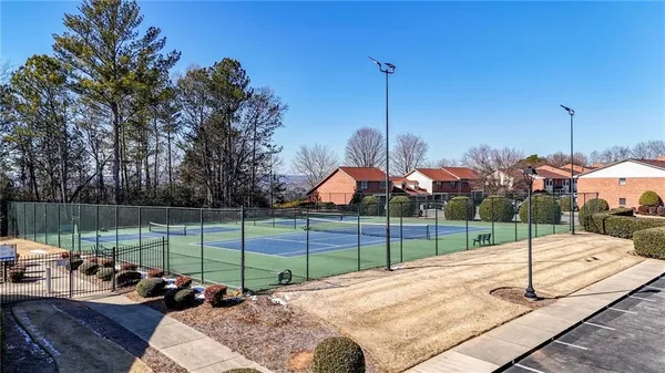 a view of a hallway with couches and wooden floor