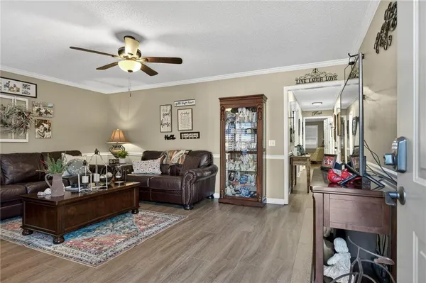 a kitchen with stainless steel appliances kitchen island granite countertop a refrigerator and cabinets