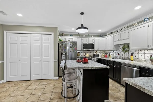 a kitchen with a sink a counter top space and stainless steel appliances