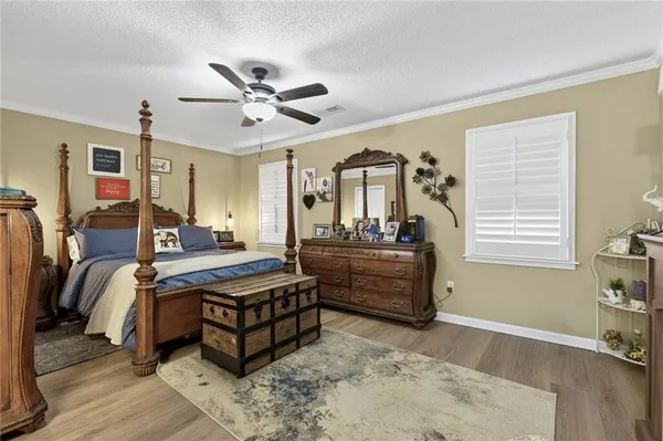 a bed room with a bed and a chair