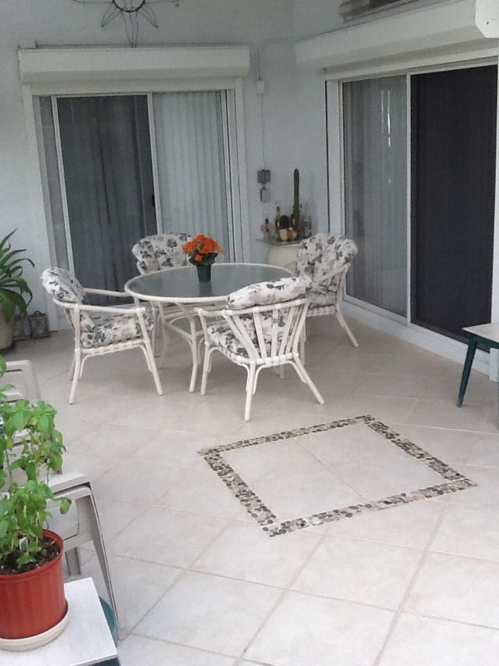 2750 Pointe Circle Greenacres, FL 33413 - Photo 11 of 14 Patio with ceramic tile & electric doors